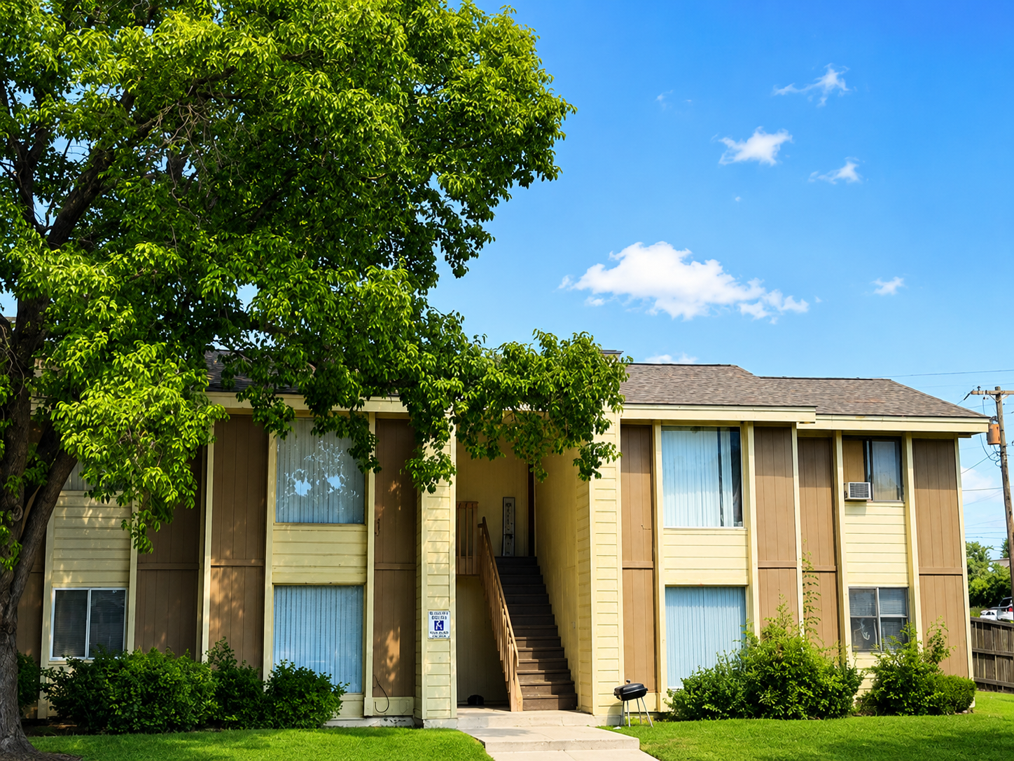 Exterior walkway and apartment building at Melrose Apartments
